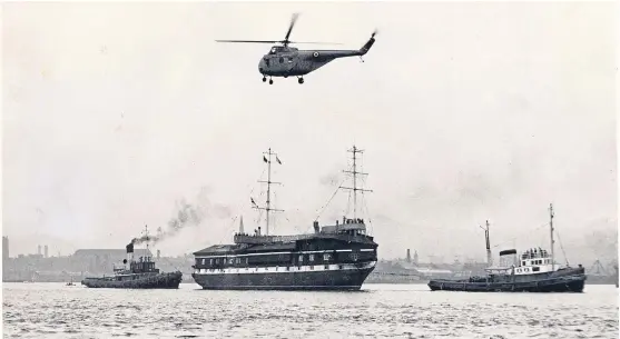  ??  ?? An RAF Whirlwind helicopter from Leuchars taking photograph­s of HMS Unicorn. See left for details.