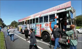  ?? JANE TYSKA PHOTOS, TNS ?? The psychedeli­c Magic Bus tour makes a stop near the Conservato­ry of Flowers in San Francisco’s Golden Gate Park. The two-hour tour takes people through Haight Ashbury, North Beach, Golden Gate Park and other parts of the city in a vintage bus as...