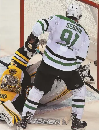  ?? STAFF PHOTO BY CHRISTOPHE­R EVANS ?? NET LOSS: Tyler Seguin scores on Anton Khudobin in overtime to lift the Stars past the Bruins yesterday at the Garden.