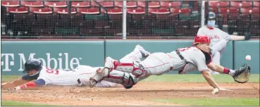  ?? WINSLOW TOWNSON — THE ASSOCIATED PRESS ?? Philadelph­ia Phillies catcher J.T. Realmuto dives for the ball one way as Boston Red Sox’s Alex Verdugo slides safely into home plate the other during the fifth inning of a baseball game Wednesday, Aug. 19, 2020, at Fenway Park in