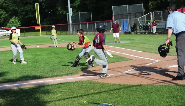  ?? Photo by Ernest A. Brown ?? Tigers catcher Joey Lezon waits for the throw to home plate as Colts baserunner Brenden Robert scores on a base hit by Mason DiDomenico in the top of the first inning Thursday at Randy Hien Field in Lincoln. The Colts prevailed, 2-1.