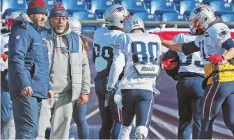  ?? STAFF PHOTO BY MATT WEST ?? SQUEEZED: Danny Amendola (80) runs through a ball security drill during yesterday’s practice inside Gillette Stadium.