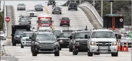  ??  ?? President Donald Trump’s motorcade travels east along Southern Boulevard near South Dixie Highway on Saturday afternoon as Trump returns to Mar-a-Lago.