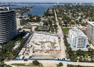  ?? PEDRO PORTAL pportal@miamiheral­d.com ?? The land where Champlain Towers South once rose is now vacant and developers are vying to build anew there.