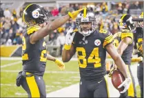  ?? Associated Press photo ?? Pittsburgh Steelers wide receiver Antonio Brown celebrates his touchdown with Stevan Ridley, left, during the first half of an NFL football game against the Carolina Panthers in Pittsburgh, Thursday.