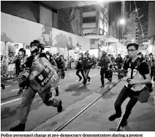  ?? PHOTO: REUTERS ?? Police personnel charge at pro-democracy demonstrat­ors during a protest in Hong Kong earlier this month