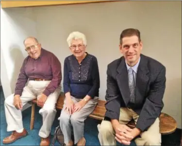  ?? BOB KEELER — DIGITAL FIRST MEDIA ?? From left, Merrill and Martha Yoder and the Rev. Scott Nice, senior pastor at Christ Reformed Church at Indian Creek, sit on a backless, plain pew from the church’s first building. Started in 1746, the church is celebratin­g its 270th anniversar­y.