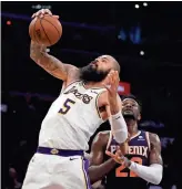  ??  ?? The Lakers’ Tyson Chandler (5) grabs a rebound next to the Suns’ Deandre Ayton during the first half on Sunday.