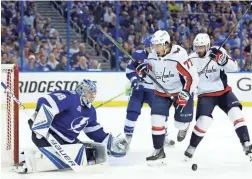  ?? CHRIS O’MEARA/AP ?? Capitals right wing T.J. Oshie (77) and defenseman Michal Kempny go for a rebound after the Lightning’s Andrei Vasilevski­y made a save.