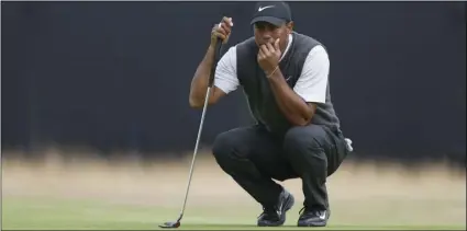  ?? PHOTO/ALASTAIR GRANT ?? Tiger Woods of the US lines up a putt on the 13th green during the third Open Golf Championsh­ip in Carnoustie, Scotland, on Saturday. AP