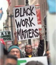  ?? SCOTT OLSON/GETTY IMAGES ?? Demonstrat­ors demand higher wages and better working conditions in Chicago on April 4, 2017, the 49th anniversar­y of King’s assassinat­ion.