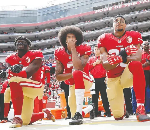  ?? Marcio Jose Sanchez / The Associat ed Press file ?? Much has changed since 2016 when Colin Kaepernick, here joined by Eli Harold, left, and Eric Reid,
began kneeling during the U. S. national anthem before games to protest racial injustice.