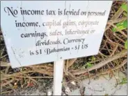 ?? JANET PODOLAK — THE NEWS-HERALD ?? Informatio­nal signs about the Bahamas are tucked along paths though the sea grapes on Half Moon Cay, an island owned by Holland America.