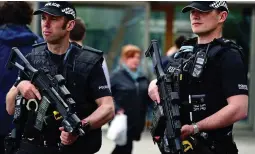  ??  ?? Alert: Armed officers at the Scottish parliament last month