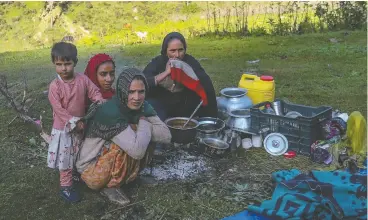  ?? ?? Ruksana Bano, front, part of the Gujjar nomadic community in Aru Valley of Jammu and Kashmir, lost a baby when heavy rain and strong winds made it difficult to get to the nearest hospital when she went into early labour.