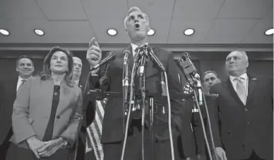  ?? GETTY IMAGES ?? Flanked by members of his incoming leadership team, House Minority Leader Kevin McCarthy, R-Calif., center, talks to reporters after the House Republican Conference voted for him to be its nominee for speaker of the House.