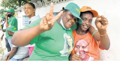  ?? RUDOLPH BROWN/PHOTOGRAPH­ER ?? Two friends, one supporting the Jamaica Labour Party and other the People’s National Party, greet each other in Woodford Park in St Andrew South Eastern on Wednesday.