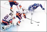  ??  ?? Tampa Bay Lightning center Carter Verhaeghe (23) and New York Islanders’ Andy Greene (4) compete for the puck as Islanders goaltender Semyon Varlamov (40) watches during the third period of Game 5 of the NHL hockey Eastern Conference final on Sept 15, in
Edmonton, Alberta. (AP)