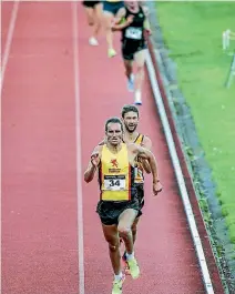  ??  ?? Hamish Carson sprints to victory in the New Zealand men’s 3000m at Newtown Park in Wellington, with Eric Speakman second.