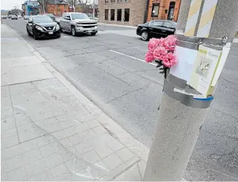  ?? JOHN RENNISON THE HAMILTON SPECTATOR ?? Flowers and a sympathy car are attached to a light pole near Locke Street after a DARTS driver was struck and killed Thursday.