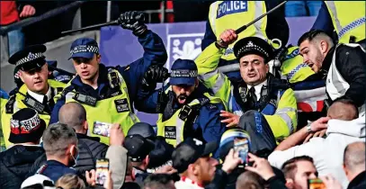  ?? EPA/SPORTIMAGE ?? Disorder: police and Hungary fans clash at Wembley and one is wounded (below)