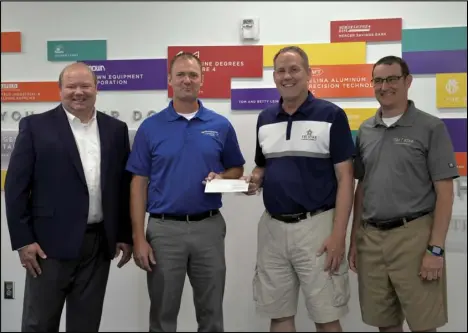  ?? Staff photo/Skyler Mitchell ?? Tri Star Director Tim Buschur (second from right) and Assistant Director Brian Stetler (far right) received a check from Midwest Electric and Buckeye Power for a project involving the installati­on of several electric charging stations at the building by Joel M. Johns (second from left) and Scott Snethkamp (far left).