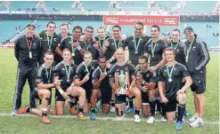  ??  ?? World champions: New Zealand coach Gordon Tietjens, left, captain DJ Forbes, with trophy, and team-mates pose for photograph­s after winning the IRB World Sevens Series Cup at Twickenham yesterday. Photo: Getty Images