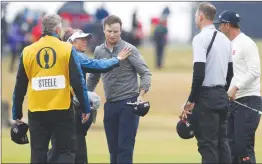  ?? Associated Press photo ?? Zach Johnson of the US, centre, is congratula­ted as he finishes the second round with Adam Scott of Australia, right, and Brendan Steele of the US of the British Open Golf Championsh­ip in Carnoustie, Scotland, Friday.