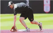  ??  ?? GLOVE STORY: Northeaste­rn University shortstop Max Burt of North Andover fields grounders as the Huskies prepare for this weekend’s NCAA baseball tournament.