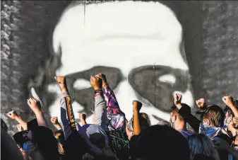  ?? Chandan Khanna / AFP / Getty Images 2020 ?? Protesters rally during a June memorial in Minneapoli­s for George Floyd, who died in police custody. The George Floyd Justice in Policing Act is a vast attempt to overhaul law enforcemen­t.