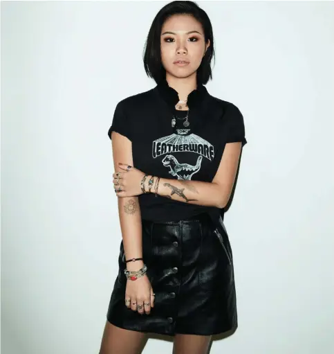  ??  ?? Cotton tee (price unavailabl­e), and calf leather skirt, $895, Coach.