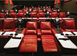  ?? CHRIS WALKER / CHICAGO TRIBUNE ?? Reclining theater seats with pivoting dining trays are among the amenities at AMC’s Dine-In Theatre at Block 37 in downtown Chicago. AMC says theaters with recliners have seen a 40 to 60 percent rise in attendance.