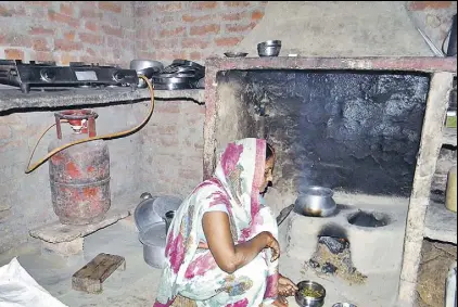 ?? ARVIND GUPTA/HT PHOTO ?? Guddi Devi of Jigni Khas village , Ballia district of Uttar Pradesh, was one of the first recipients of the ~8,000crore project. She now uses the stove sparingly to save fuel, for quick snacks or tea for guests but not for daily cooking.