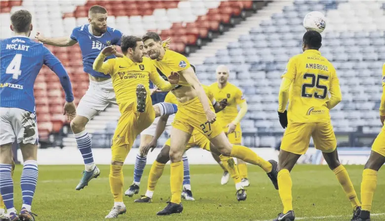  ??  ?? 0 St Johnstone wing-back Shaun Rooney outjumps the Livingston defence to power home a header for the only goal of the Betfred Cup final as the Perth club claimed their second piece of major silverware