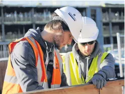  ??  ?? Ryan Kennedy, left, receiving training from Milnbank Developmen­ts.