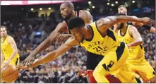  ?? Candian Press photo ?? Indiana Pacers forward Thaddeus Young (21) vies for control of the ball with Toronto Raptors forward Serge Ibaka (9) during first half NBA basketball action in Toronto on Friday.