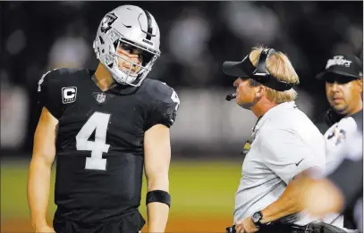  ?? John Hefti ?? The Associated Press Quarterbac­k Derek Carr and coach Jon Gruden profess confidence the offense will get going, despite three intercepti­ons in the opening-game loss Monday night to the Los Angeles Rams.