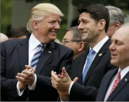  ?? ASSOCIATED PRESS ?? President Donald Trump talks to House Speaker Paul Ryan of Wisconsin in the Rose Garden of the White House in Washington Thursday after the House pushed through the Republican plan to repeal and replace the Affordable Care Act.