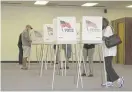  ?? MIKE MORONES/THE FREE LANCE-STAR VIA AP ?? People vote in Spotsylvan­ia, Virginia, on Friday, the first day of the state’s 45-day early voting period.