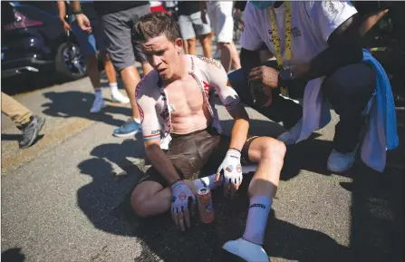  ?? The Canadian Press ?? Luxembourg’s Bob Jungels catches his breath after crossing the finish line during the eighteenth stage of the Tour de France cycling race over 143.5 kilometers with start in Lourdes and finish in Hautacam, France