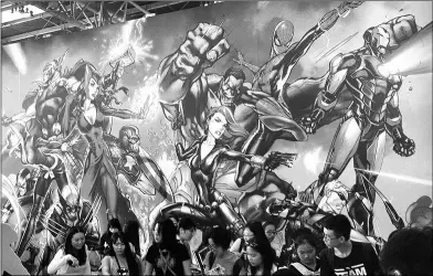  ?? ZHANG ZHAO / CHINA DAILY ?? A giant poster with Marvel characters is seen at a comics exhibition in Beijing.