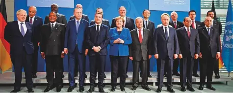  ?? Reuters ?? British Prime Minister Boris Johnson, Turkish President Recep Tayyip Erdogan, French President Emmanuel Macron, German Chancellor Angela Merkel, Russian President Vladimir Putin, Egyptian President Abdul Fattah Al Sissi, Algerian President Abdul Madjid Tebboune and UAE Foreign Minister Shaikh Abdullah Bin Zayed Al Nahyan with other dignitarie­s in Berlin yesterday.