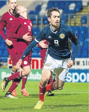  ??  ?? Ryan Hardie salvaged a point for the Scotland U21s with a stoppage-time penalty against 10-man Latvia U21s at Mcdiarmid Park. Picture: SNS.