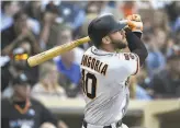  ?? Denis Poroy / Getty Images ?? Giants third baseman Evan Longoria homers in the third inning, his fourth in three games.