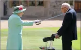  ?? (AP/Chris Jackson) ?? Queen Elizabeth II confers knighthood on Thomas Moore as they stand outside Windsor Castle on Friday.