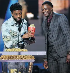  ?? KEVIN WINTER/GETTY IMAGES FOR MTV ?? Chadwick Boseman, left, presents his best hero award for Black Panther to James Shaw Jr.