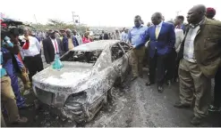  ?? — AFP ?? NAIROBI: Kenyan Vice President William Ruto (2nd-R) visits the crash site of a truck that rammed into several vehicles before bursting into flames near Karai on the busy Naivasha highway.