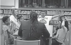  ??  ?? Milwaukee Journal Sentinel columnist James E. Causey (back to camera) asks a group of third-graders at Samuel Clemens Elementary School a number of questions while visiting the school recently. The children said violence and bullying rank near the top of the list of problems they face. Participat­ing are (from left) Serenity Davis, 9; Kelsey Robison, literacy coach; Keonna White, 8; D’Andre Houston, 9; Nevaeha Ware, 9; and Abrayah Scull, 9.