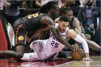  ?? JOHN AMIS — THE ASSOCIATED PRESS ?? The 76ers’ Ben Simmons (25) and Atlanta’s Taurean Prince left, and guard Isaiah Taylor vie for a loose ball during the first half Tuesday in Atlanta.