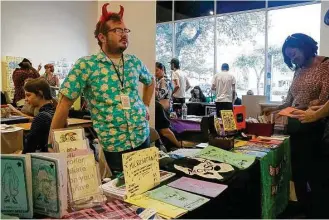  ?? Greg Fails / Houston Chronicle ?? Conner Clifton, a former NPR reporter, mans a booth Sunday at the Houston Zine Fest. Artists, poets and others gather there annually to sell, trade and hand out works they have self-published.